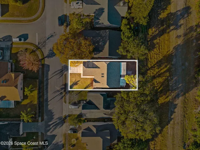 an aerial view of a house with swimming pool