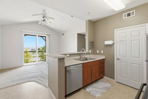 a bathroom with a granite countertop sink a toilet and a mirror