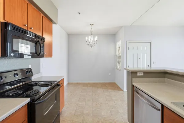 an empty room with a chandelier fan