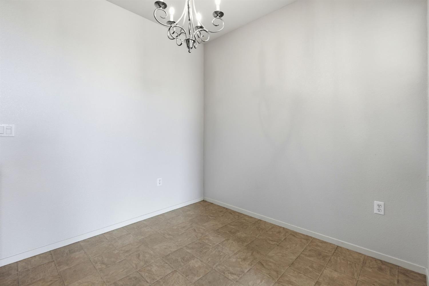 1240 Whitney Ranch Parkway, Unit PW338 Rocklin, CA 95765 - Photo 18 of 58 an empty room with a chandelier fan