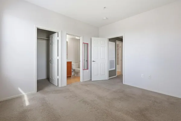 a bathroom with a bathtub shower sink vanity mirror and toilet