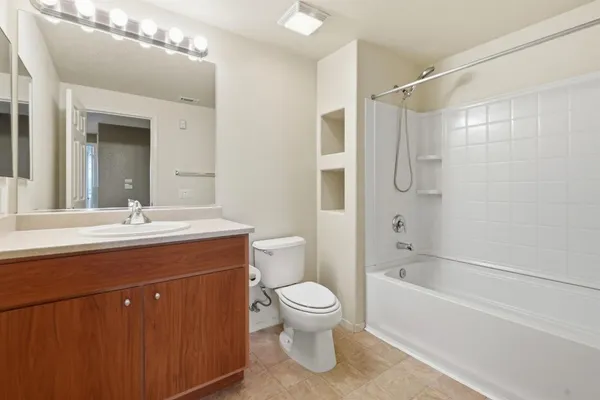 a front view of a house with yard and parking