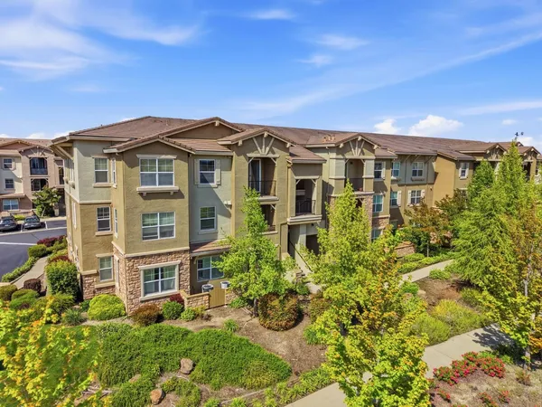 an aerial view of residential houses with outdoor space and swimming pool
