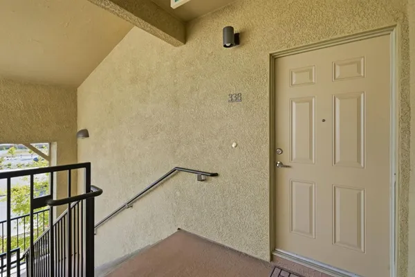 an empty room with sliding door and wooden floor