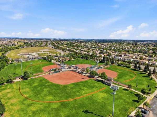 a view of an empty room with window and cabinet
