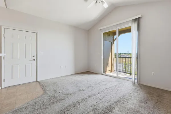 a view of a hallway with a white cabinet and a refrigerator