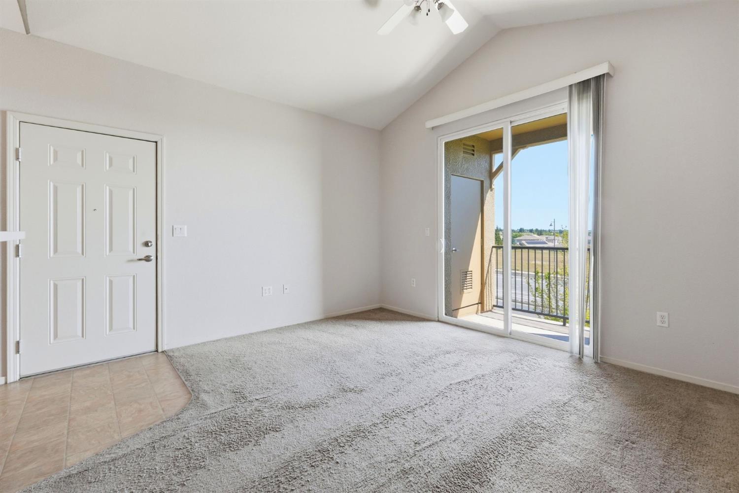 1240 Whitney Ranch Parkway, Unit PW338 Rocklin, CA 95765 - Photo 5 of 58 an empty room with sliding door and wooden floor