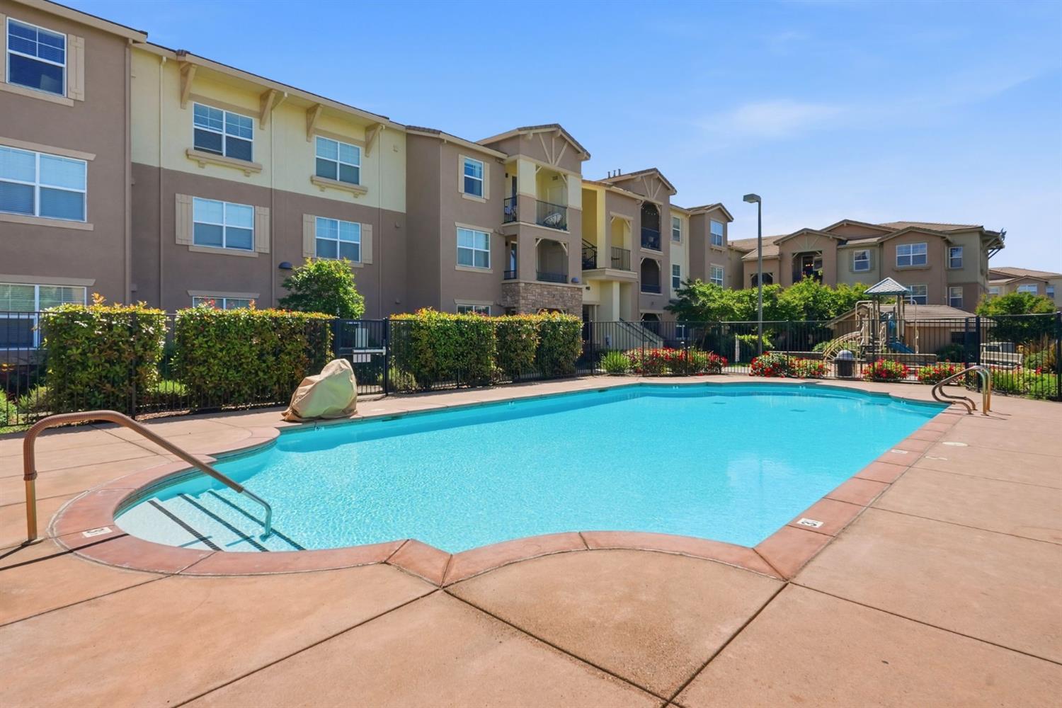 1240 Whitney Ranch Parkway, Unit PW338 Rocklin, CA 95765 - Photo 55 of 58 a view of a swimming pool and a lounge chair
