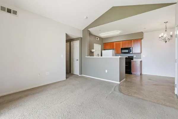 a view of a kitchen with a sink and cabinets