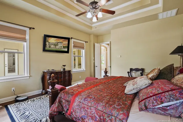 a bedroom with a bed wooden floor and a window