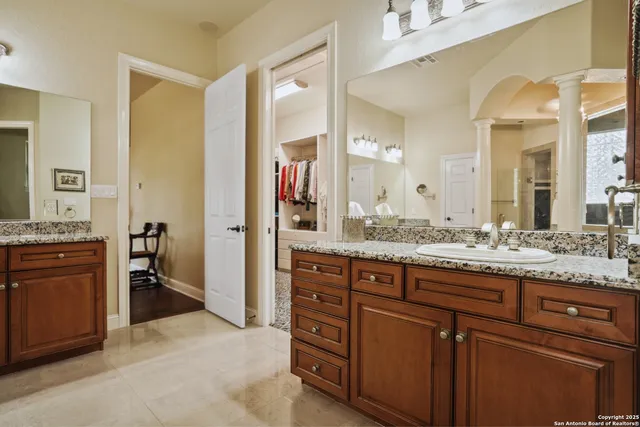 a kitchen with stainless steel appliances kitchen island granite countertop a stove a sink and a refrigerator