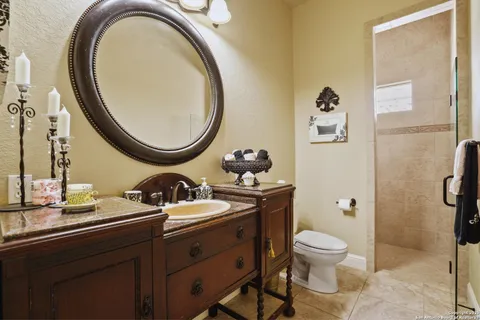 a bedroom with a bed a chandelier and a window