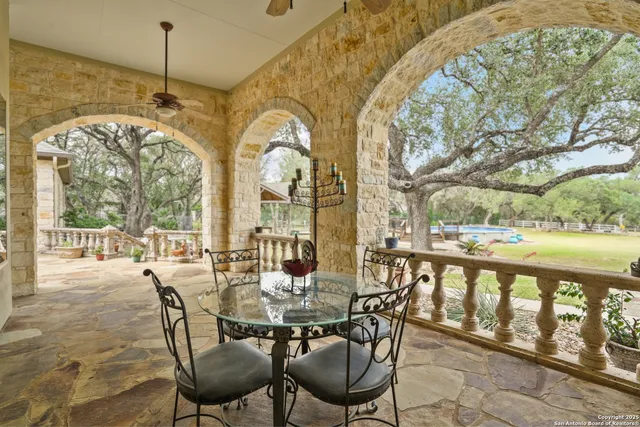 a view of a patio with a table chairs and a backyard