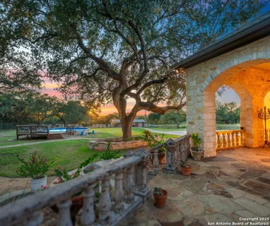 a view of a patio with a table chairs and a backyard
