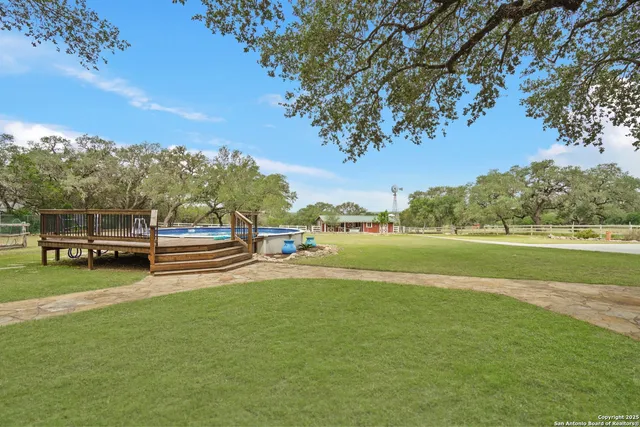 a view of a swimming pool with a yard