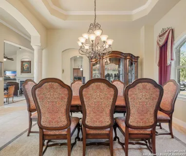 a dining room with furniture and chandelier
