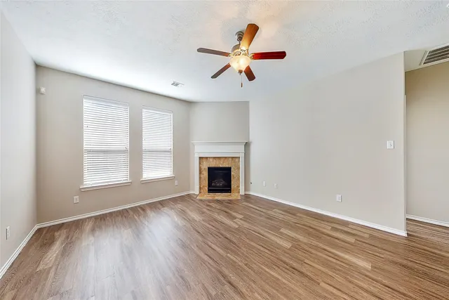 a view of a kitchen with wooden floor and a ceiling fan