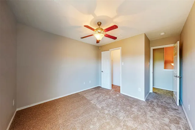 a view of a house with wooden fence