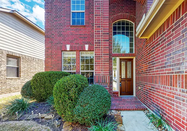 a view of a brick house with a large windows