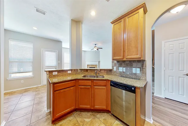 a kitchen with stainless steel appliances granite countertop a sink stove and cabinets