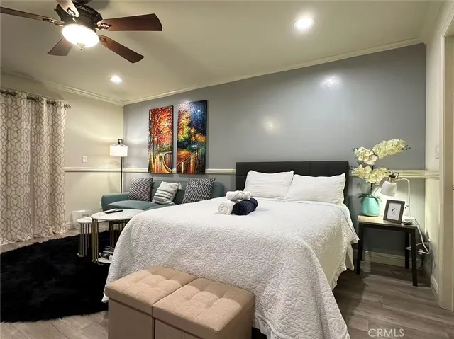 a bedroom with a bed and ceiling fan