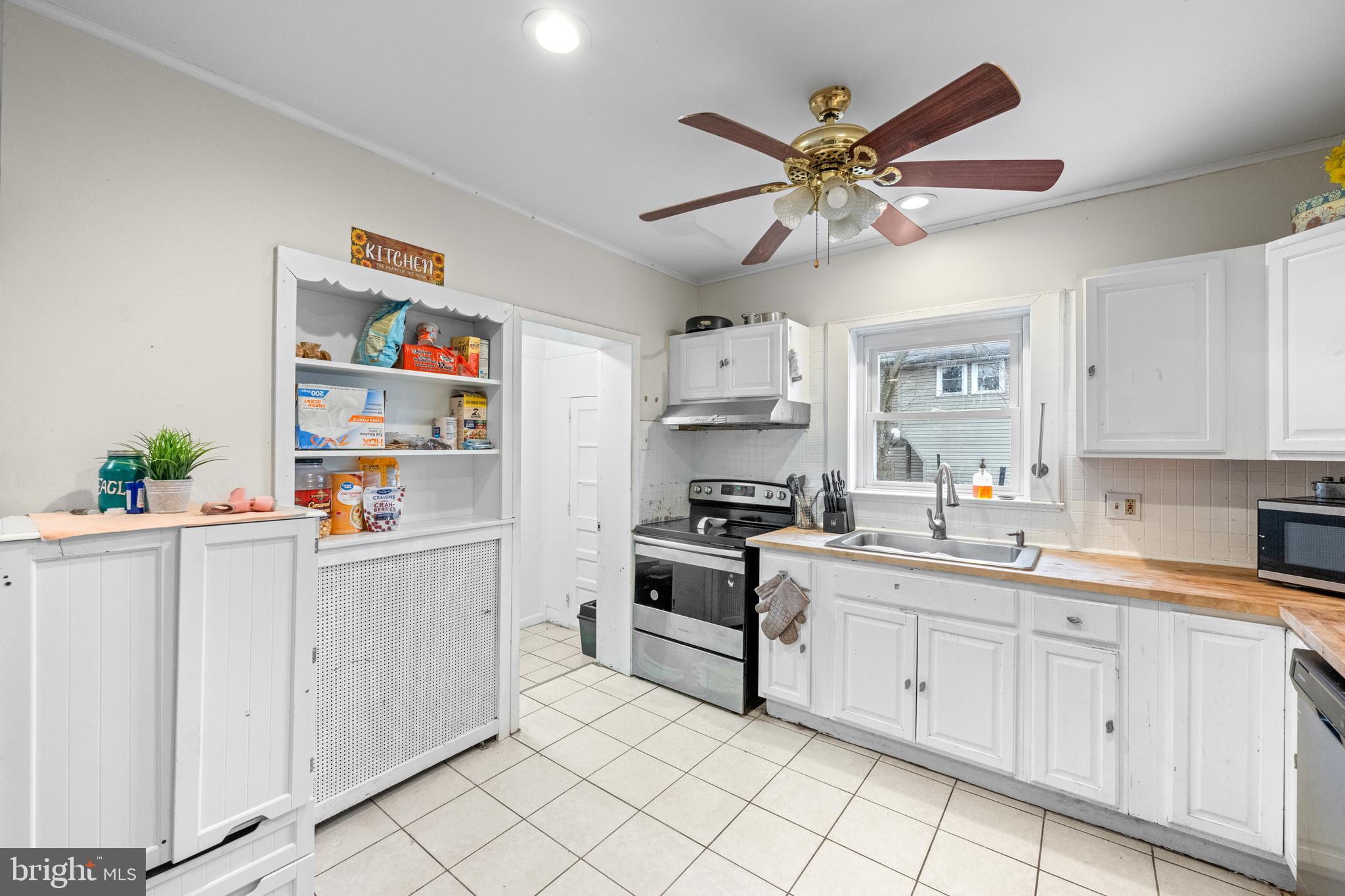 1009 Queen Street Pottstown, PA 19464 - Photo 11 of 17 a kitchen with cabinets a sink and white stainless steel appliances