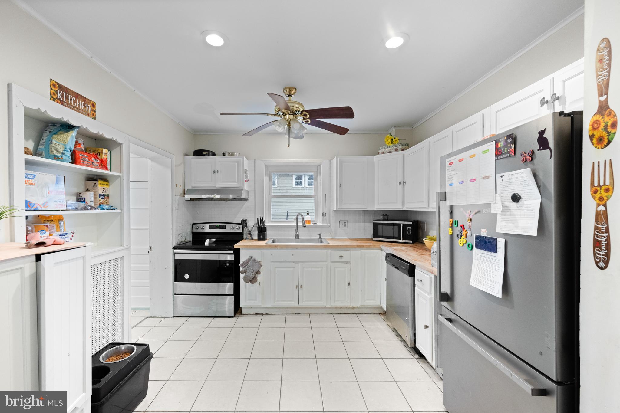 1009 Queen Street Pottstown, PA 19464 - Photo 9 of 17 a kitchen with stainless steel appliances and white cabinets