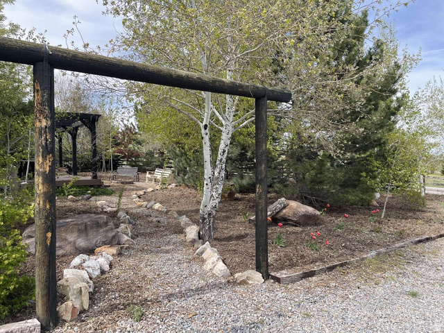 7030 West 2100 North Mendon, UT 84325 - Photo 10 of 67 Landscaped outdoor area featuring a gravel path framed by natural stone