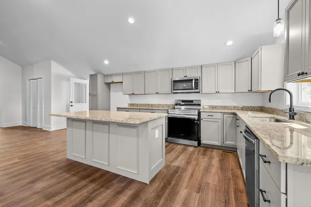 a bathroom with a granite countertop double vanity and a sink