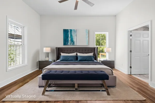 an empty room with windows and fan