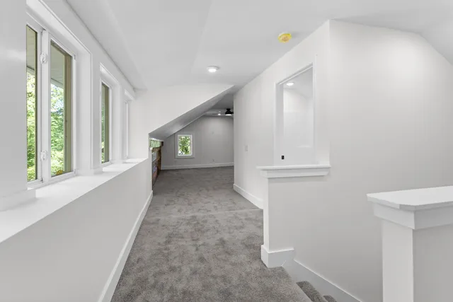 a bathroom with a toilet a sink and wooden floor