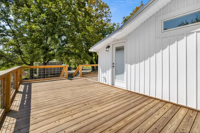 a view of a house with a tree in the background