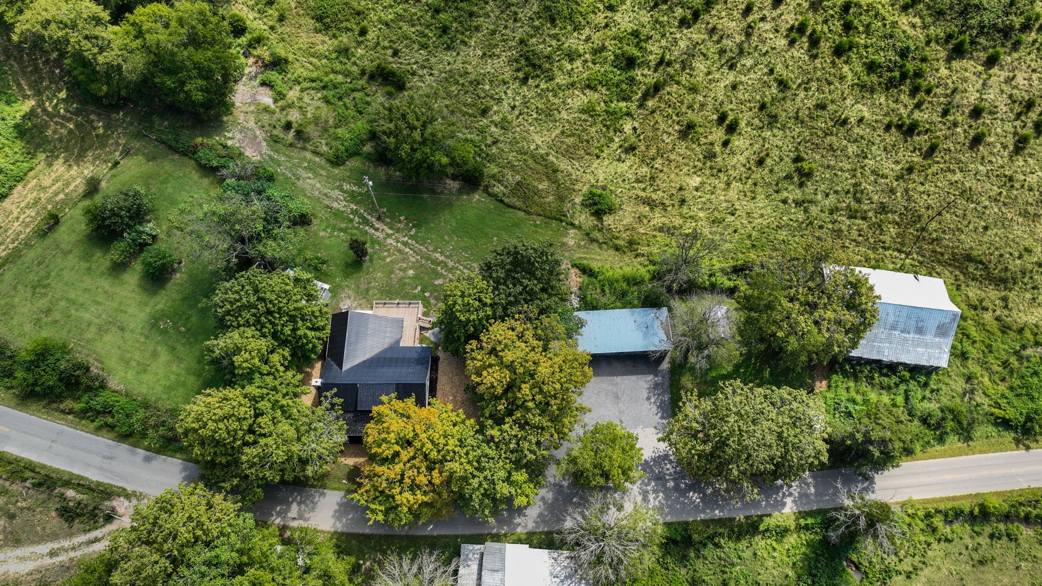 1881 New Herman Road Fayetteville, TN 37334 - Photo 54 of 58 an aerial view of a house with a yard and large trees