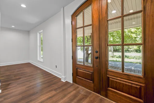 a living room with furniture kitchen view and a flat screen tv