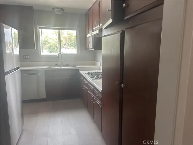 a kitchen with cabinets and window