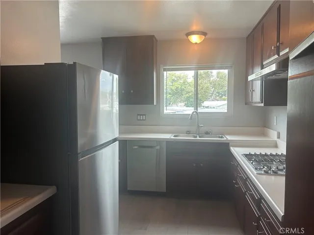 a kitchen with refrigerator and window