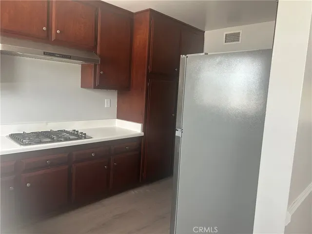 a kitchen with a stove and a refrigerator