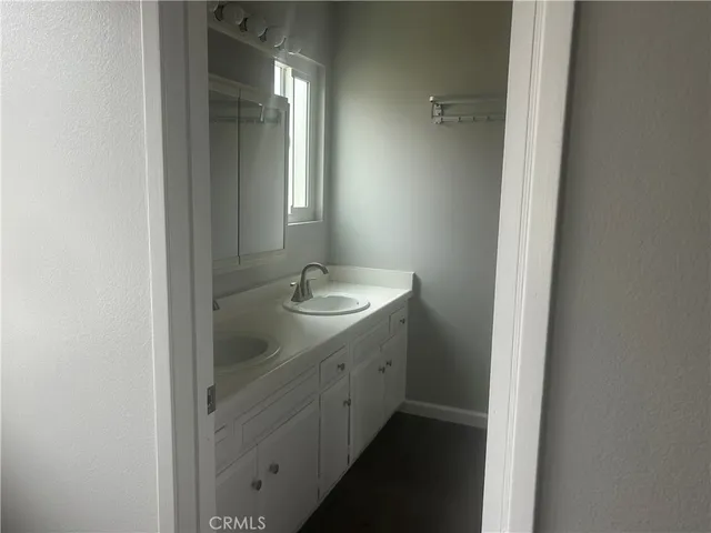 a bathroom with a double vanity sink and mirror