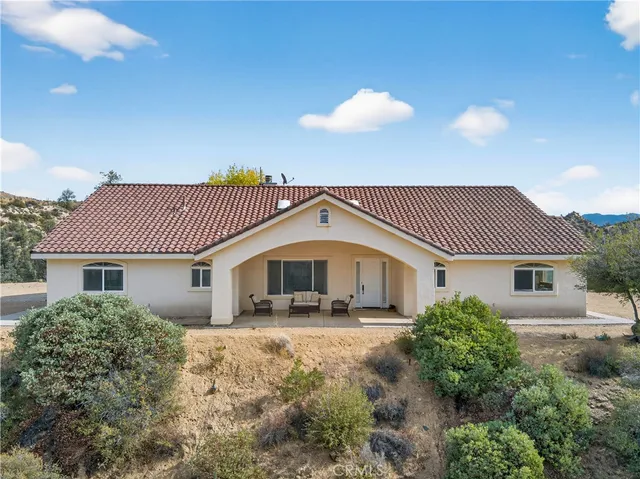 a view of a livingroom with furniture and a window