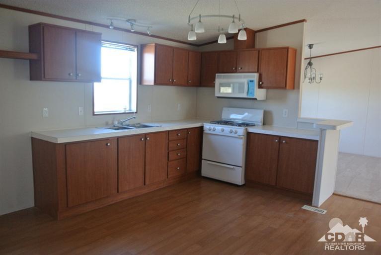 15488 Desert View Road Whitewater, CA 92282 - Photo 14 of 19 a kitchen with stainless steel appliances granite countertop a stove a sink dishwasher and a microwave oven with cabinets