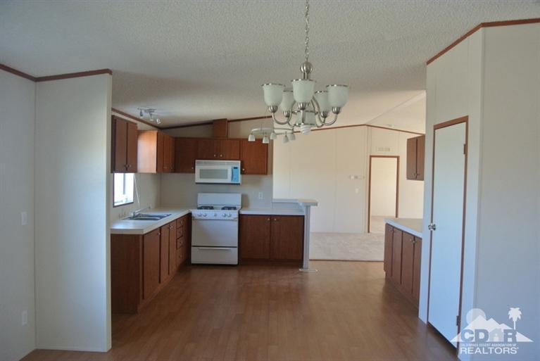 15488 Desert View Road Whitewater, CA 92282 - Photo 15 of 19 a view of kitchen and kitchen with stainless steel appliances granite countertop cabinets and wooden floor