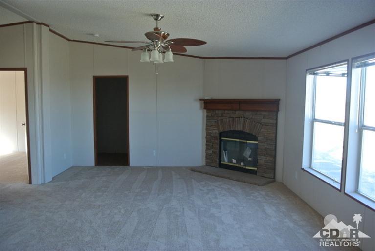 15488 Desert View Road Whitewater, CA 92282 - Photo 16 of 19 a view of a livingroom with a fireplace and window