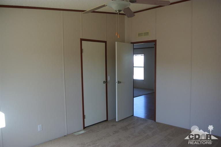 15488 Desert View Road Whitewater, CA 92282 - Photo 18 of 19 a view of a hallway with wooden shelves