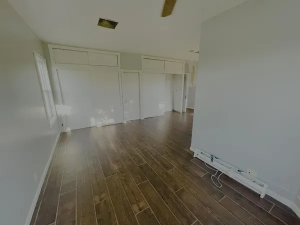 a view of a room with wooden floor