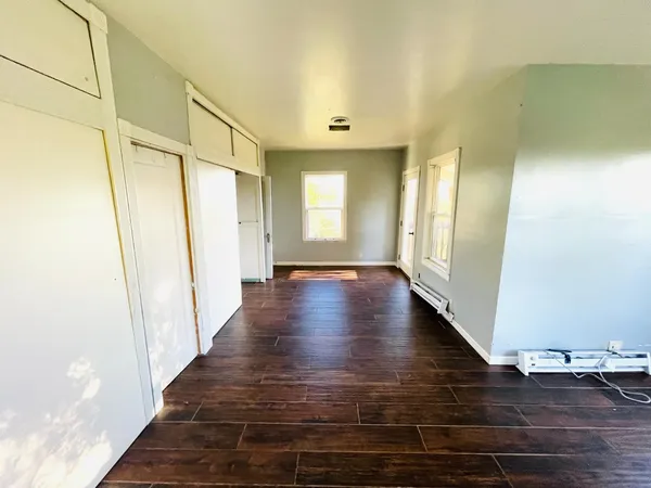 a view of a hallway with wooden floor