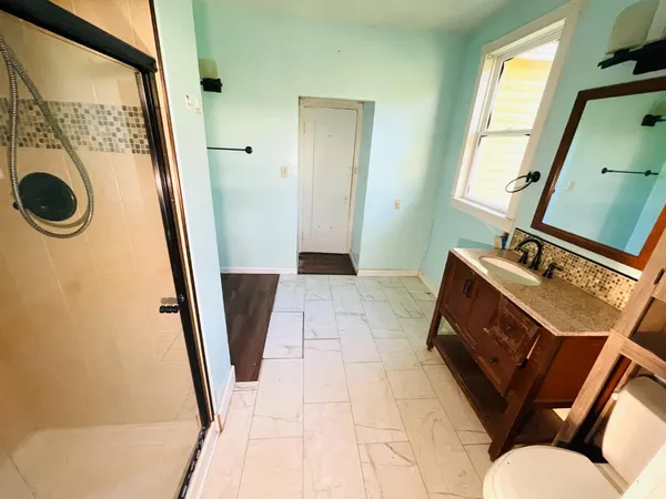 a view of a bathroom with a sink and a mirror