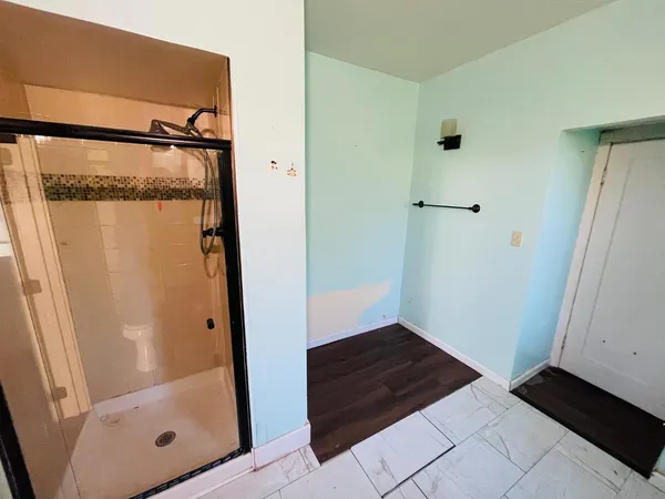 a bathroom with a glass shower door