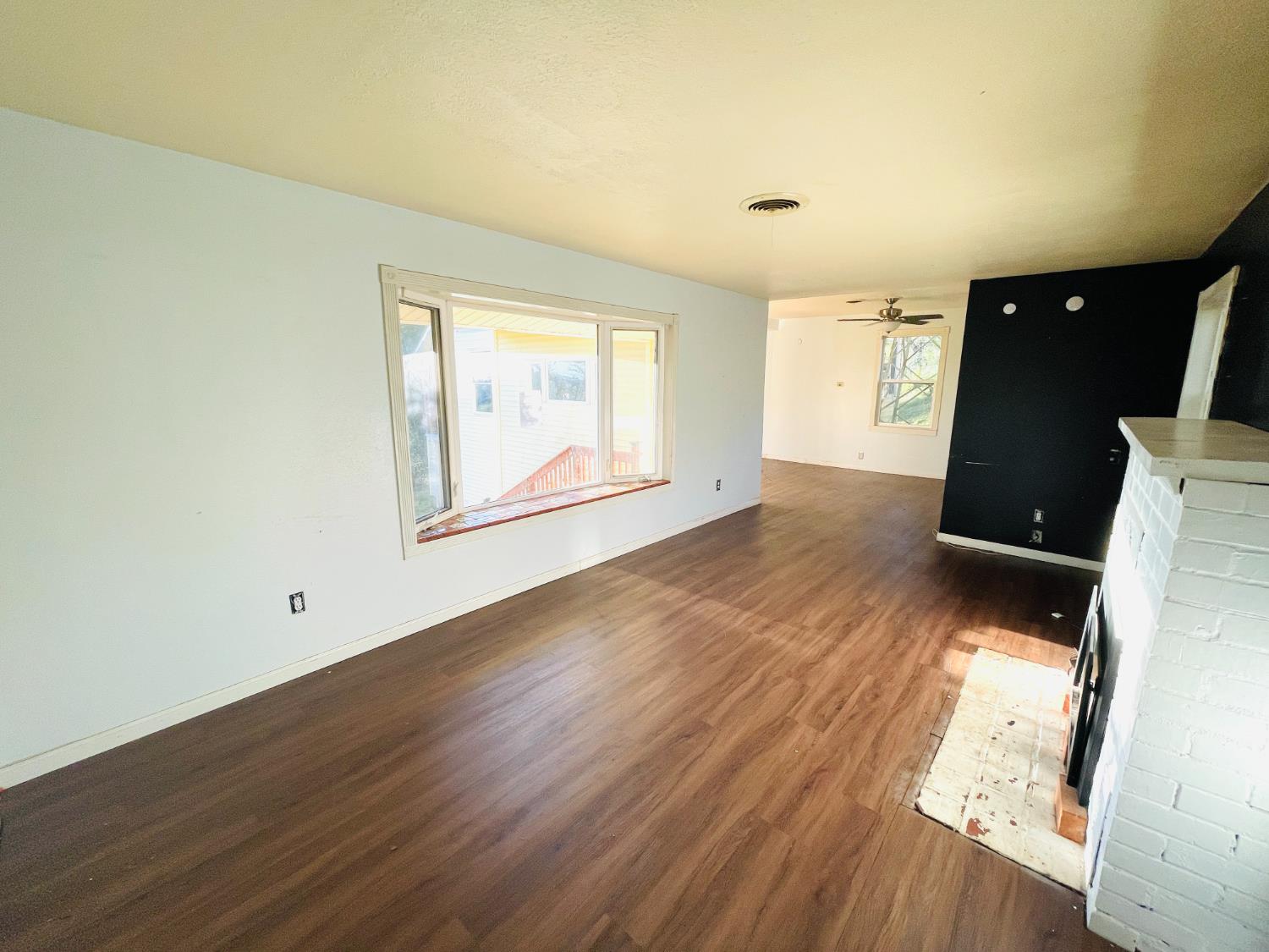 210 South Summit Street Ione, CA 95640 - Photo 27 of 27 an empty room with wooden floor and windows