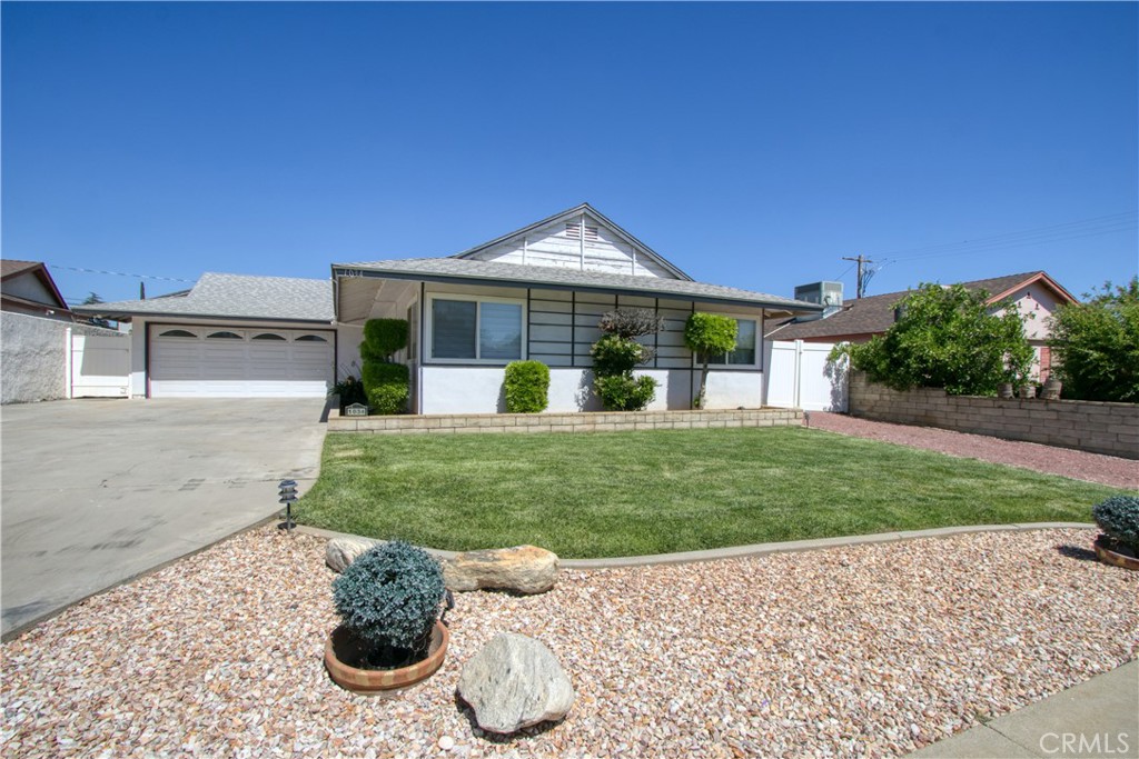 1034 Thompson Avenue Banning, CA 92220 - Photo 2 of 24 a front view of a house with a yard