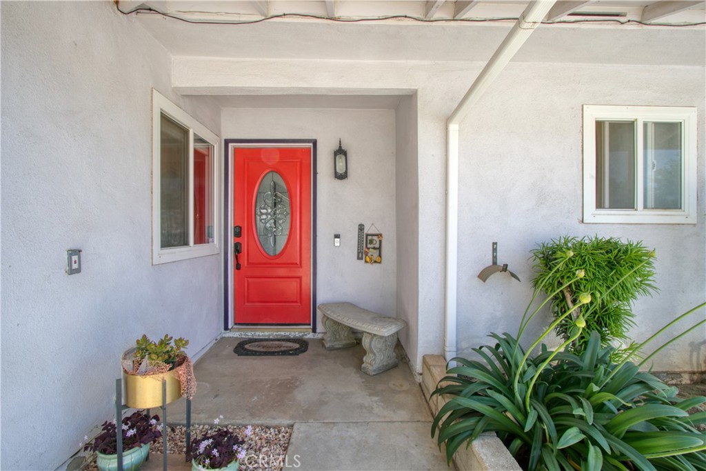 1034 Thompson Avenue Banning, CA 92220 - Photo 21 of 24 a view of front door with yellow lighting